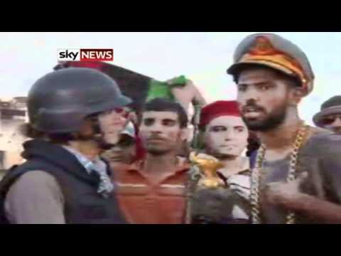 Rebel Fighter Bags Gaddafi's Hat