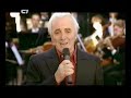 the lyrics in french and english.

ils sont tomb�s 
charles aznavour

ils sont tomb�s sans trop savoir pourquoi 
hommes, femmes et enfants qui ne voulaient que vivre 
avec des gestes lourds comme des hommes ivres 
mutil�s, massacr�s les yeux ouverts d'effroi 
ils sont tomb�s en invoquant leur dieu 
au seuil de leur �glise ou le pas de leur porte 
en troupeaux de d�sert titubant en cohorte 
terrass�s par la soif, la faim, le fer, le feu 

nul n'�leva la voix dans un monde euphorique 
tandis que croupissait un peuple dans son sang 
l' europe d�couvrait le jazz et sa musique 
les plaintes de trompettes couvraient les cris d'enfants 
ils sont tomb�s pudiquement sans bruit 
par milliers, par millions, sans que le monde bouge 
devenant un instant minuscules fleurs rouges 
recouverts par un vent de sable et puis d'oubli 

ils sont tomb�s les yeux pleins de soleil 
comme un oiseau qu'en vol une balle fracasse 
pour mourir n'importe o� et sans laisser de traces 
ignor�s, oubli�s dans leur dernier sommeil 
ils sont tomb�s en croyant ing�nus 
que leurs enfants pourraient continuer leur enfance 
qu'un jour ils fouleraient des terres d'esp�rance 
dans des pays ouverts d'hommes aux mains tendues 

moi je suis de ce peuple qui dort sans s�pulture 
qu'a choisi de mourir sans abdiquer sa foi 
qui n'a jamais baiss� la t�te sous l'injure 
qui survit malgr� tout et qui ne se plaint pas 
ils sont tomb�s pour entrer dans la nuit 
�ternelle des temps au bout de leur courage 
la mort les a frapp�s sans demander leur �ge 
puisqu'ils �taient fautifs d'�tre enfants d'arm�nie


they fell
charles aznavour


they fell that year, they vanished from the earth, 
never knowing the cause, or what laws they'd offended,
the women fell as well, and the babies they tendered,
left to die, left to cry, all condemned by their birth.

they fell like rain, across the thirsty land,
in their heart they were slain, in their god still believing,
all their pity and pain, in that season of grieving,
all in vain, all in vain, just for one helping hand.

for no one heard their prayers, in a world bent on pleasure, 
from other people scared, they simply closed their eyes,
they create a lot of sound, in jazz and right time measure,
the trumpets screamed till dawn, to drown the children's cries.

they fell like leaves, its people, in its prime,
simple man, kindly man, and not one knew his crime, 
they became in an hour, like the small desert flower, 
soon covered by the silent wind, in sands of time.

they fell that year, before a cruel foe, 
they had little to give, but their lives, and their passion, 
and their longing to live, in their way, in their fashion,
so their harvest could thrive, and their children could grow. 

they fell like flies, their eyes still full of song, 
like a dove in its flight, in the path of a rifle, 
that folds on where it might, as if death were a trifle, 
and to bring to an end, a life barely begun.

and i am of that race, who died in unknown places,
who perished in their pride, whose blood in rivers ran, 
in agony and fright, with courage on their faces 
they went into the night, that waits for every man.

they fell like tears, and never knew what for, 
in that summer of strife, of massacre and war, 
their only crime was life, there only guilt was being, 
the children of armenia, nothing less nothing more.