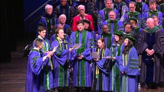 Graduates on stage at commencement ceremony