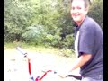 the kid thats rides a bike in a dangerous river