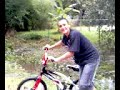the kid thats rides a bike in a dangerous river