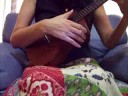 A ukulele beginner plays 