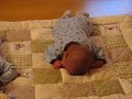 Gabriel learning to crawl while Michael sleeps