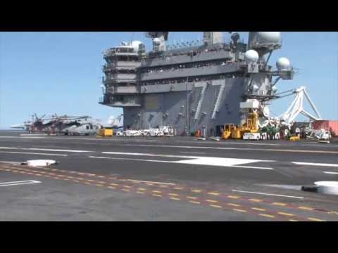 Touch - An X-47B Unmanned Combat Air System (UCAS) demonstrator conducts a touch and go landing on the flight deck of the aircraft carrier USS George H.W. Bush (CVN ...