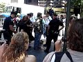 Anti-War protest at the UN, sept, 2007.  Some of the police were trying to drag protest organizers out of the designated protest-zone so they could then arrest them for leaving the protest zone.  This video captures a protest organizer (girl in orange) in the permitted protest zone struggling with a police officer who is trying to pull her out and arrest her.  Her status as an organizer would have been obvious as she was wearing an orange suit (a reference to Guantanamo prisoners), and signing people onto a mailing list with a clipboard (which was knocked out of her hands in the struggle).  The officer was unsuccessful, as the surrounding protesters would not let go of her.  This created a type of tug-of war over the organizer.  When the officer losses his grip, the group falls backward.  They then move forward towards the barricade to confront the officer, who is then pushed back by the commanding officer (white uniform).  The commanding officer then prepares to spray the organizer (girl in orange) and another protester with pepper spray.  The two protesters run back into the crowd, which then begins to shun the police for their actions.  No one at this moment was sprayed.  Meanwhile, others in the video are being arrested outside of the barricade.  I am unaware if they left the permitted protest-zone on their accord. Indeed others, perhaps those in the latter part of the video, purposely left the protest-zone as an act of civil-disobedience.  They too were arrested.