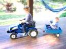Dain and Jai riding tractor