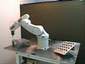 Adept Viper robot placing pegs on angled board