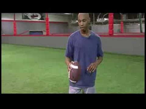 how to be better at football - In order to throw a football better, a player should know how to properly hold a football. Throw a football better with tips from a football coach in this fr...
