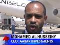 British billionaire Sir Richard Branson signed a deal Tuesday to sell a third of his space travel startup to a Mideast investment fund. Soon after, Branson took his first ride in WhiteKnightTwo, designed to launch a ship into space. (July 28)