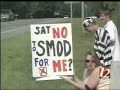 Story on WXII Channel 12 News from 6 p.m. on July 9th 2007 about People Opposed To Standard Mode Of Dress protesting at Rockingham County Board of Education meeting about school uniforms.  The board later that night voted to rescind its earlier mandate for uniforms at two Reidsville schools by a vote of 7 for rescinding, 3 against and 2 abstaining.  Members of POTSMOD came to the meeting wearing black armbands, in costume (prison stripes and Jedi Knight) and carrying picket signs.