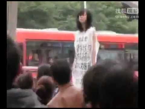Chinese Nude Model - A Chinese women dressed only with her slogans and standing on a garbage can protested in front of the Supreme Court in Guiyang, China on November 14. 2011. A...