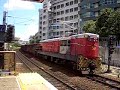Northbound KCR freight, X911 heads by...
