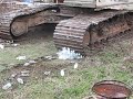 Running over water bottles with a track hoe