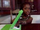 Sneha (2) explores her OLPC one-laptop-per-child laptop