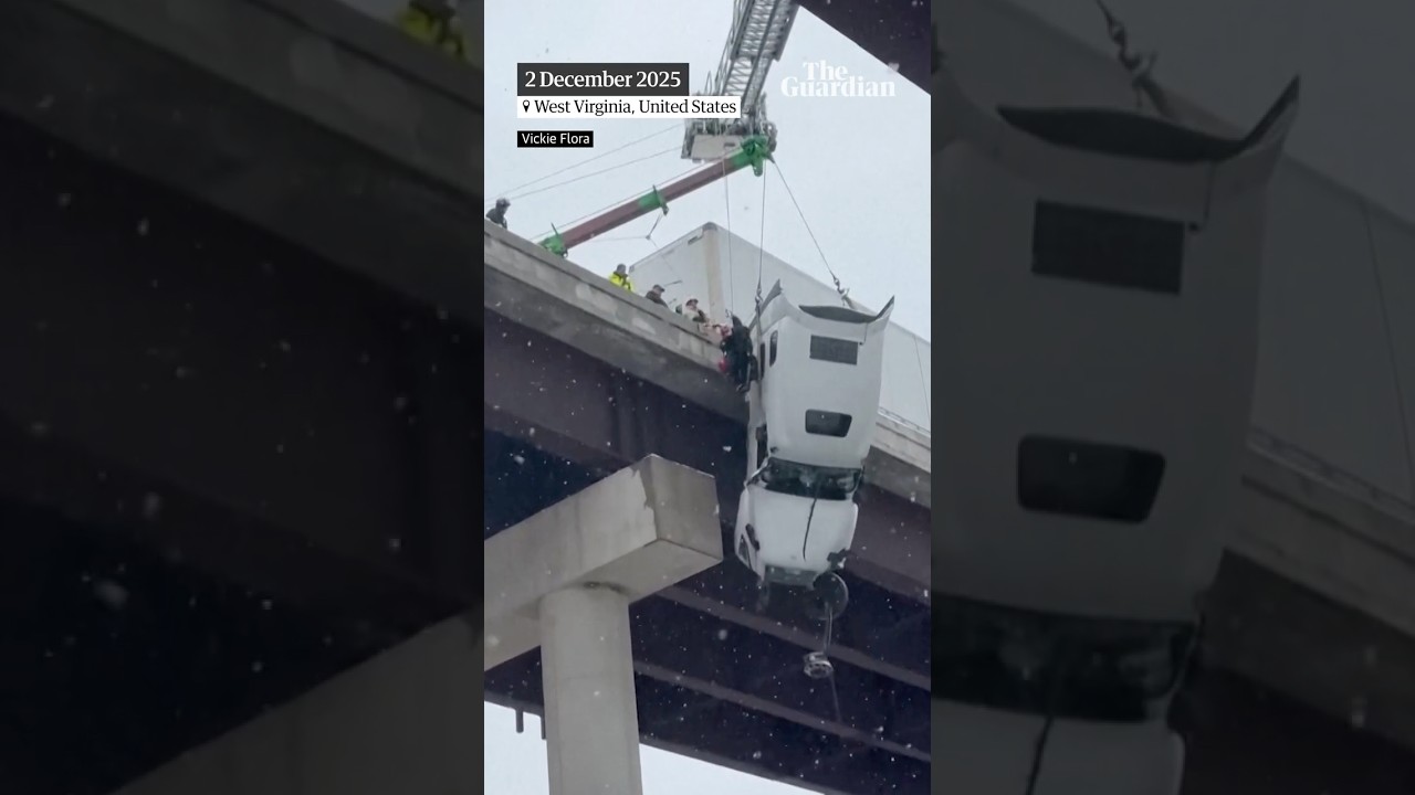 Driver rescued from truck dangling from side of bridge as heavy snowfall hits US