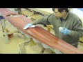 Applying stain to western red cedar strips. The stain is then evened out with a denatured alcohol wipe down. Stain on the accent stripe is scraped off with a utility knife. This is from aseries of videos showing the steps of building a wooden kayak using the 