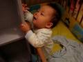 Cyrus stands up in his cot....