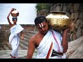 you can download a good quality version from http://rapidshare.com/files/107852447/nadageethe_0001.wmv.html

?? ???? ????? ???????,?? ?? ??????? ????
?? ????? ??????? ???? ?? ?? ?? ????? ????.
??????? ????? ??????? ???? ???? ??????? ?????
???? ??????????????? ???? ????? ??????? !

????? ????? ???? ???,?????? ????? ?????????,
?????? ?????? ????, ?????? ?????? ????,
???? ????? ???? ??????,???? ????? ??????? !

???? ??????? ??????????,??????????? ??????????
???? ??????? ?????,??? ???????? ????
????????????? ???? ???,??? ???????? ?????????
???? ??????? ????? ???? ????? ??????? !

???? ??????????? ????,???? ???? ?????? ????
????? ?????? ????,??????? ?? ???
?????? ?????? ??????,???? ????? ??????? !

???? ?????? ?????? ???,????? ???? ??????? ???
????? ??????? ????????,?????? ??????????
???? ????? ?????? ???,???? ??????????
????? ???? ????????? ???,????? ????? ????? ???
???? ????? ???????,?? ?? ??????? ????
                          - ?? . ???????
'jai bharatha jananiya thanujathe' is a famous and a very beautiful song patriotic song of the land written by a great kannadiga, rashtra kavi dr. k. v. puttapa (kuvempu). the song is also the state anthem of karnataka.

the beauty and the central theme of the song is that it envisages a karnataka that is very proud of its position in the comity of indian states. mother karnataka is called a proud daughter of mother india who believes in peaceful co-existence with her sisters, but at the same time maintains her self-respect and dignity.

through the poem, the poet appreciates the greatness of the state of karnataka by highlighting its glorious culture, divinity and heritage, architectural splendor, geographical treasures, the great kings, poets, intellects of the land and peaceful co-existence of people in diversity.

the translation of the song  into english (as in wikipedia) reads - 

victory to you mother karnataka, the daughter of mother india! 
hail the land of beautiful rivers and forests, hail the abode of saints! 
you are a new jewel in the crown of goddess earth, mine of beautiful gold and sandal. 
victory to you mother karnataka the daughter of mother india where rama and krishna had their incarnations.

resonance of the vedas is your mother's lullaby for you, and your fervor is her life. lines of green mountains are your necklaces. 
victory to you mother karnataka, the daughter of mother india who is hailed by kapila, patanjali, gautama and jina.

you are a sacred forest where shankara, ramanuja, vidyaranya and basaveswara dwelt. you are the holy abode where ranna, shadakshari, ponna, pampa, lakshmisha and janna were born. 
you are the blessed resting place of many a poet-nightingales. victory to mother karnataka, the daughter of mother india who gave birth to nanak, ramanand and kabir.

this is the land ruled (in the past) by tailapa and hoysalas, and affectionate hometown for dankana and jakkana. this land is the blessed stage for krishna, sharavathi, tunga and kaveri. victory to you mother karnataka, the daughter of mother india of chaitanya, paramahamsa and vivekananda.

garden of peace for all communities, a sight that allures the connoisseurs, the garden where the hindus, christians, muslims, parsis and the jains (grow); the palace of many kings that are like janaka; the place for singers and musicians; the body of the children of mother kannada -- the house where kannada tongue plays in joy. 

victory to you mother karnataka, the daughter of mother india. hail the land of beautiful rivers and forests, hail the abode of rasarishis!
