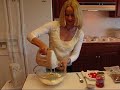 In this video, Betty demonstrates how to make a gorgeous and flavorful Lime Mist Gelatin Salad. It uses lime Jello, but is mixed with applesauce and lime-lime soda. The topping is cream cheese, marshmallows, and whipped cream, garnished with some beautiful maraschino cherry slices and chopped pecans. This is a side dish, accompanying Betty's Sunday evening meal. Scrumptious, and a delight to look at!!! Ingredients: 20 oz. applesauce 1 small package lime Jello (I used sugar-free.) 1 cup lemon lime soft drink, 7-up is fine. (I used diet soda.) 3 oz. cream cheese, cut into small cubes 2 cups miniature marshmallows 1/2 pint whipping cream Heat 20 oz. applesauce in a medium-sized saucepan, and dissolve a small package of lime gelatin in it. Add 1 cup of lemon-lime soda, and stir. Pour into a nice medium to large-sized clear serving bowl. Cover with plastic wrap and refrigerate 8 hours or overnight. Combine 3 oz. cream cheese, cut in small cubes, with 2 cups marshmallows, and 1/2 pint of whipping cream in a large mixing bowl. Cover with plastic wrap and refrigerate 8 hours or overnight. The next day, use a mixer to beat the marshmallow mixture until thick. (There can still be some lumps of marshmallows in it, if desired.) Spread over the gelatin salad. Garnish with a small amount of sliced maraschino cherries and chopped pecans (about 8 cherries and 1/2 cup chopped pecans.) Cover with plastic wrap and refrigerate until ready to serve. A splendid addition to almost any meal!