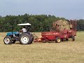 Click here to watch this video New Holland TN65 baling hay