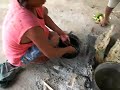 Shipibo woman preparing fish