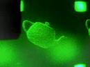 the movie shows a rotating teapot by our electroholography 3d display system. the system consists of 3 lcd panels(3*1920*1080 pixel cgh), a green laser and some lenses.
in principle, an electroholographic 3d display can reconstruct a natural 3d images in space. however, it is difficult to reconstruct such a 3d images.
the problems of the small size and the narrow viewing zone for a reconstructed 3d object are essentially caused by the rough pixel pitch and the low resolution of an lcd panel. in order to enlarge the viewing angle and the size, an lcd panel for a cgh must have a large displaying area and a minute pixel pitch, because the viewing angle is proportional to the displaying area and the size is inversely proportional to the pixel pitch, respectively.
for instance, a method solving the problems can equivalently enlarge the resolution and miniaturize the pixel pitch by tiling some lcds and using lenses.

for more details, please visit our homepage.

http://gabor.yz.yamagata-u.ac.jp/~shimo/