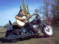 Glen Maldonado playing 12-string guitar on Harley Fat Boy Glen Maldonado playing 12-string guitar on Harley Fat Boy