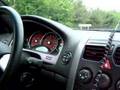 black 2004 GTO passing some cars