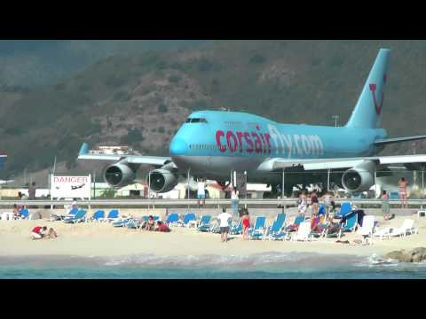 airports - Boeing 747 landing and taking off from St. Maarten in the Carribean, one of the World's scariest airports. Viewed from a catamaran 100 metres off the beach.