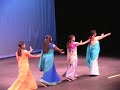 The dance performance shows traditionally dressed young girls performing telugu folk style dance depicting the nativity of rural areas of south India .