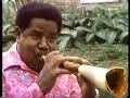 sugar belly playing his bamboo saxophone
