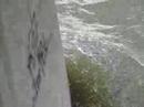 Water breaking against a bridge
