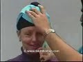 To begin, hold a long piece of fabric on the diagonal, and roll in the long edges. Then, grasp on to one end while bringing the other end behind and over the top of your head diagonally.  Wrap fabric smoothly at an angle around your head. After the second loop, carefully twist fabric on one side, bringing it down from your forehead and around, creating a ridge. Repeat this twist on every other turn so that the fabric crosses in front, working your way up. After several turns (about six times for an adult), tuck in the end under the top of the turban; secure with pins. Carefully undo the first loop, and pull the remaining end (the one held in your teeth) underneath the front of the turban to cover the back of your head. Tuck the end into the back of the turban, and secure with pins.  Confused yet?  Hopefully the Illustrations below with shed some light on the delicate art of tying a turban. http://www.sikhpoint.com/religion/resources/importanceofturban.htm