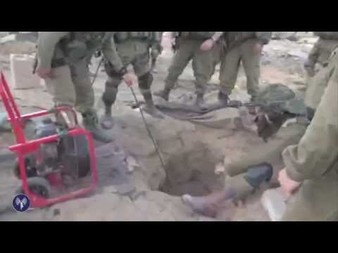 tunnel - Soldiers from the Givati Infrantry Brigade uncover and enter a concealed terror tunnel in Gaza, discovering weapons and explosives. Since July 8, IDF forces in Gaza have uncovered 30 tunnels...