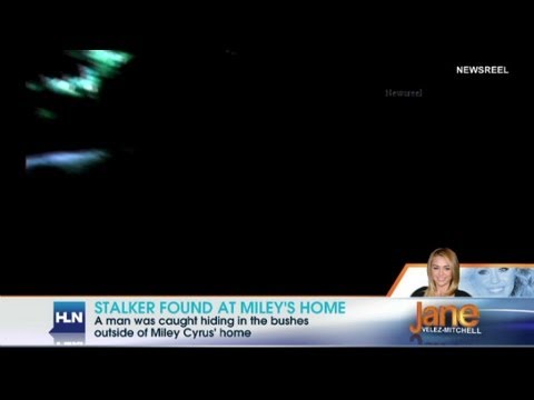 arrrested - A man was caught hiding in the bushes outside of the singer's home.
