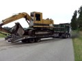 Tandem dumptruck hauling excavator on tag trailer