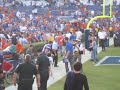 Tebow signing an autograph for a kid.