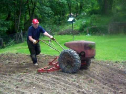 david bradley tractor - Just finishing up the garden wanted to show those who are not familiar with them, how the attachments hook up , and the Spike tooth Harrow at work.