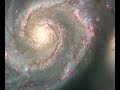 a pan of the whirlpool galaxy that reveals the fine details captured by hubble's advanced camera for surveys across the spiral arms, dust lanes, and galaxy companion.