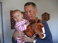 eden and grandpa riding her new christmas present.