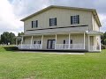 Our home sits on a grass runway on the shore of Lake Harney in Florida. The lawn in front of the home is actually the taxiway. Our goal was to take what could have been an ugly facade and make it more 