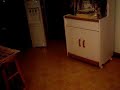 A fat guy sliding acroos a floor and into a cupboard A fat guy sliding acroos a floor and into a cupboard