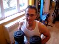 Georg is training his arms with heavy barbells