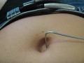 Navel torture using a piece of steel wire