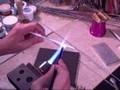 Duda makes glass beads - encased stringer