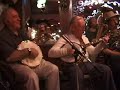 jim robinson, tenor banjo, plays carolina in the morning with eddy davis, tenor banjo, mike hashim, saxophone, ed polcer, coronet, paul bacon, comb, peter sokolow, piano, and brian nalepka, tuba, at the cajun in nyc on october 15th, 2003.