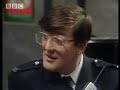 Funny sketch featuring Hugh Laurie and Stephen Fry. A man returns from holiday to find his local police station has undergone some serious renovations! Great clip from BBC comedy show 'A Bit of Fry & Laurie'.