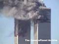 Rooftop view of both towers burning. Shot of people...