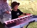 Blind child playing piano and singing 