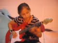 Awesome Little girl playing fallen leaves on electric guitar